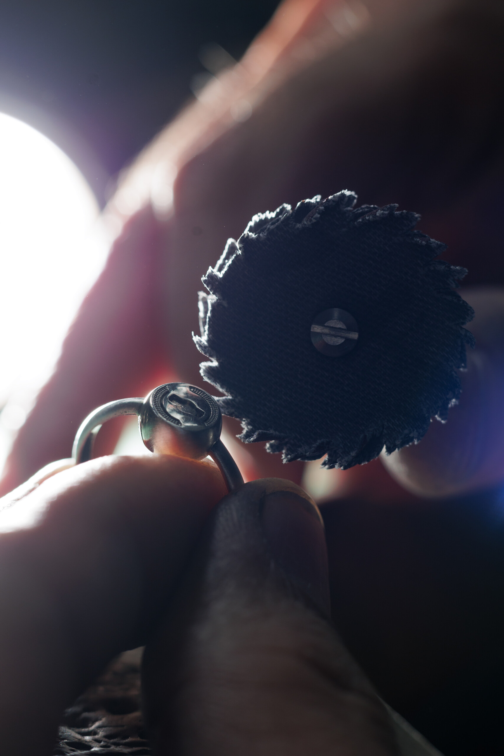 Close-up of a silver Joolet Ring being repaired by hand.